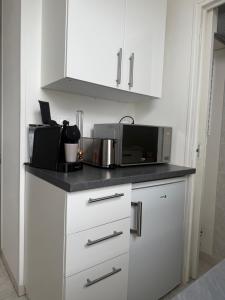 a kitchen with a counter top with a microwave at Chez Ben et Lou in Envermeu