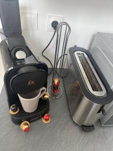 a coffee maker sitting on a counter next to a mixer at Chez Ben et Lou in Envermeu +4 photos