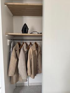 a walk in closet with coats on racks at Chez Ben et Lou in Envermeu