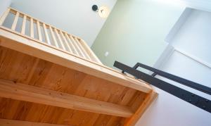 a wooden staircase with a light on the ceiling at Le Perchoir d'Orthez in Orthez