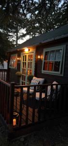 a small house on a deck with a porch at Swan cove - Lakeside Caravan Park in Denver