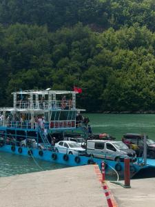 a ferry boat with people on it in the water at Drini Guesthouse in Tropojë