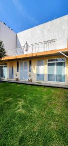 a house with a lawn in front of it at Acogedor loft privado en Coyoacán in Mexico City