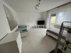 a bedroom with a bed and a tv in it at Ruhig gelegene Ferienwohnung in Waldbrunn