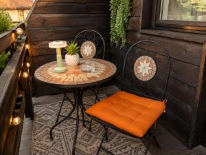 a small table and chairs on a patio at OTILIA apartment in Zell am See