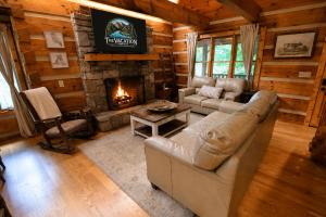 a living room with a couch and a fireplace at The Highland in Cherokee