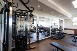 a gym with several treadmills and weights at The Atlas° Hotel in Regina