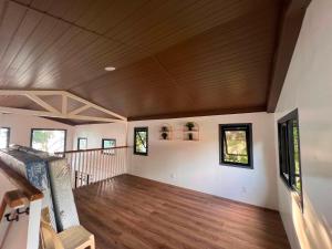 a large living room with a wooden ceiling at Seaside traveler's Inn by Camiguin Island Home in Catarman