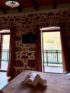 a bedroom with a bed with a towel on it at Kyma in Gerolimenas