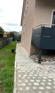 a side of a building with a stone walkway at Ruhig gelegene Ferienwohnung in Waldbrunn