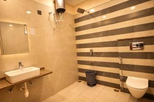 a bathroom with a sink and a toilet at Hotel River Front in Kota