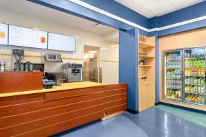 a restaurant with a counter and a refrigerator with drinks at Marriott's Cypress Harbour Villas in Orlando