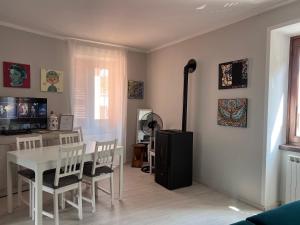 a dining room with a white table and chairs at Mezze Lune in Braone