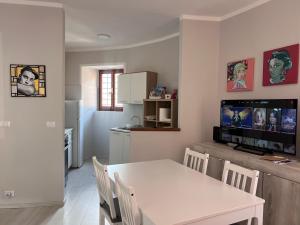 a kitchen and dining room with a table and a tv at Mezze Lune in Braone
