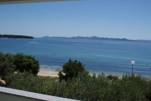 a view of a body of water with a beach at Apartments Jurjevic in Petrcane