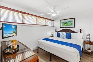a bedroom with a bed and a window at OB - Lahaina Roads 308 in Lahaina
