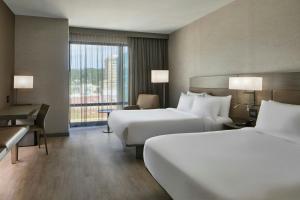 a hotel room with two beds and a desk at AC Hotel Asheville Downtown in Asheville +87 photos