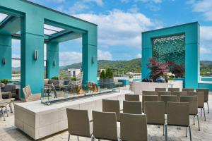 a patio with chairs and a fire pit at AC Hotel Asheville Downtown in Asheville