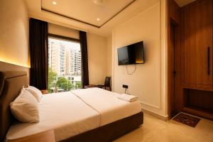 a hotel room with a bed and a window at Hotel River Front in Kota