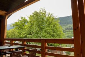 a view from the porch of a cabin with a tree at Cottage Deera in Mestia