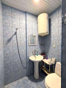 a bathroom with a shower and a sink and a toilet at Legacy Rooms in Old Tbilisi FREE parking in Tbilisi City