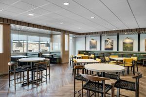 a dining room with tables and chairs and windows at Fairfield by Marriott Inn & Suites Mattoon in Mattoon