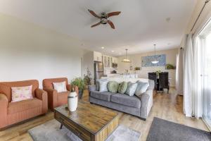 a living room with a couch and a table at Unwind centrally in West Kelowna