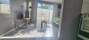 a room with a television and a bed and a window at Cantinho das Orquídeas! in Pelotas