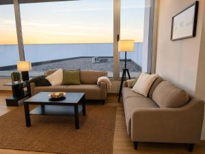 a living room with two couches and a coffee table at Bodega Díscolo in Zamora