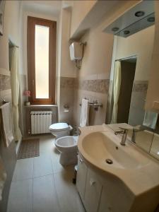 a bathroom with a sink and a toilet and a mirror at Chimera 37's in Avezzano +9 photos
