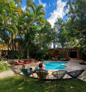 a group of people sitting in chairs by a pool at Costa Rica Backpackers in San José