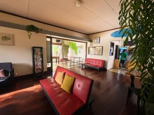 a living room with a red couch and a table at Costa Rica Backpackers in San José