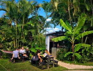 a group of people sitting at picnic tables in a park at Costa Rica Backpackers in San José