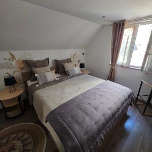 a bedroom with a large bed in a room with windows at Gîte Vallée de Munster 3 étoiles chez Flavie & Ludo in Muhlbach-sur-Munster