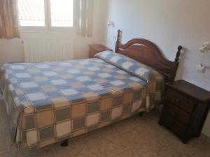 a bedroom with a bed and a dresser in it at Alojamiento CR Cuatro Caminos in San Pablo de los Montes