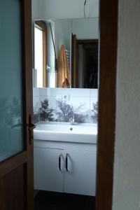 a bathroom with a white sink and a mirror at Villa Harmonia in Ferizaj +9 photos