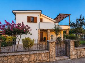 a house with a fence in front of it at Villa Maslina in Ljubuški