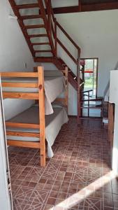 a room with two bunk beds and a staircase at Brisas Del Rio Apart Hotel in Termas del Daymán +103 photos