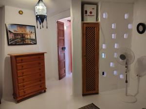 a room with a dresser and a room with a fan at La Muralla in Yunquera