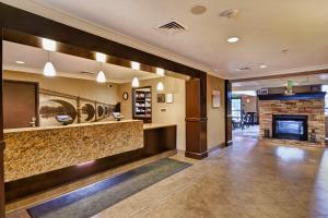 a lobby of a hotel with a fireplace at Staybridge Suites Madison - East by IHG in Madison