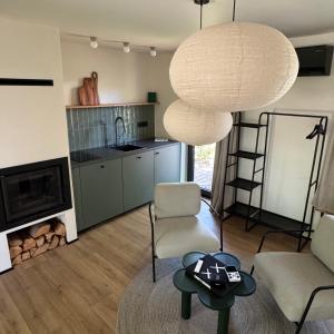 a living room with a couch and a table and a chandelier at Garden 52 in Šutovce +7 photos