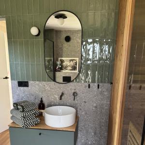 a bathroom with a sink and a mirror at Garden 52 in Šutovce