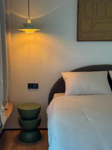 a bedroom with a bed and a light on the wall at Garden 52 in Šutovce