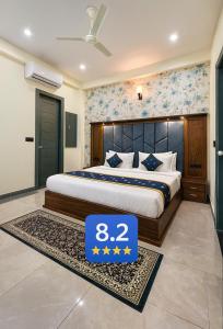 a bedroom with a bed with a sign in the middle at Hotel Urban Stay - Mathura in Mathura