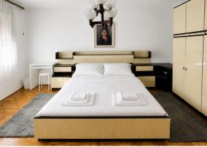 a bedroom with a large bed in a room at L&M Apartman in Virje