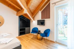 two blue chairs in a room with a window at Hotel Villa Amabile in Villa dʼAllegno