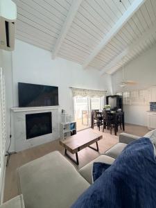 a living room with a couch and a table at Two Bedroom Beach Apartment in Sunset Beach