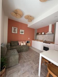 a living room with a couch and a kitchen at AL do Barão - Casa de Charme com Piscina Privada in Vila Real de Santo António
