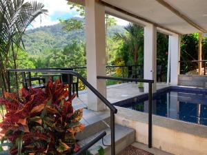 a house with a balcony with a swimming pool at Bambura Hermosa villas in Uvita