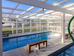 a large swimming pool with a glass ceiling at Kaakupe Praia Hotel in Guaratuba